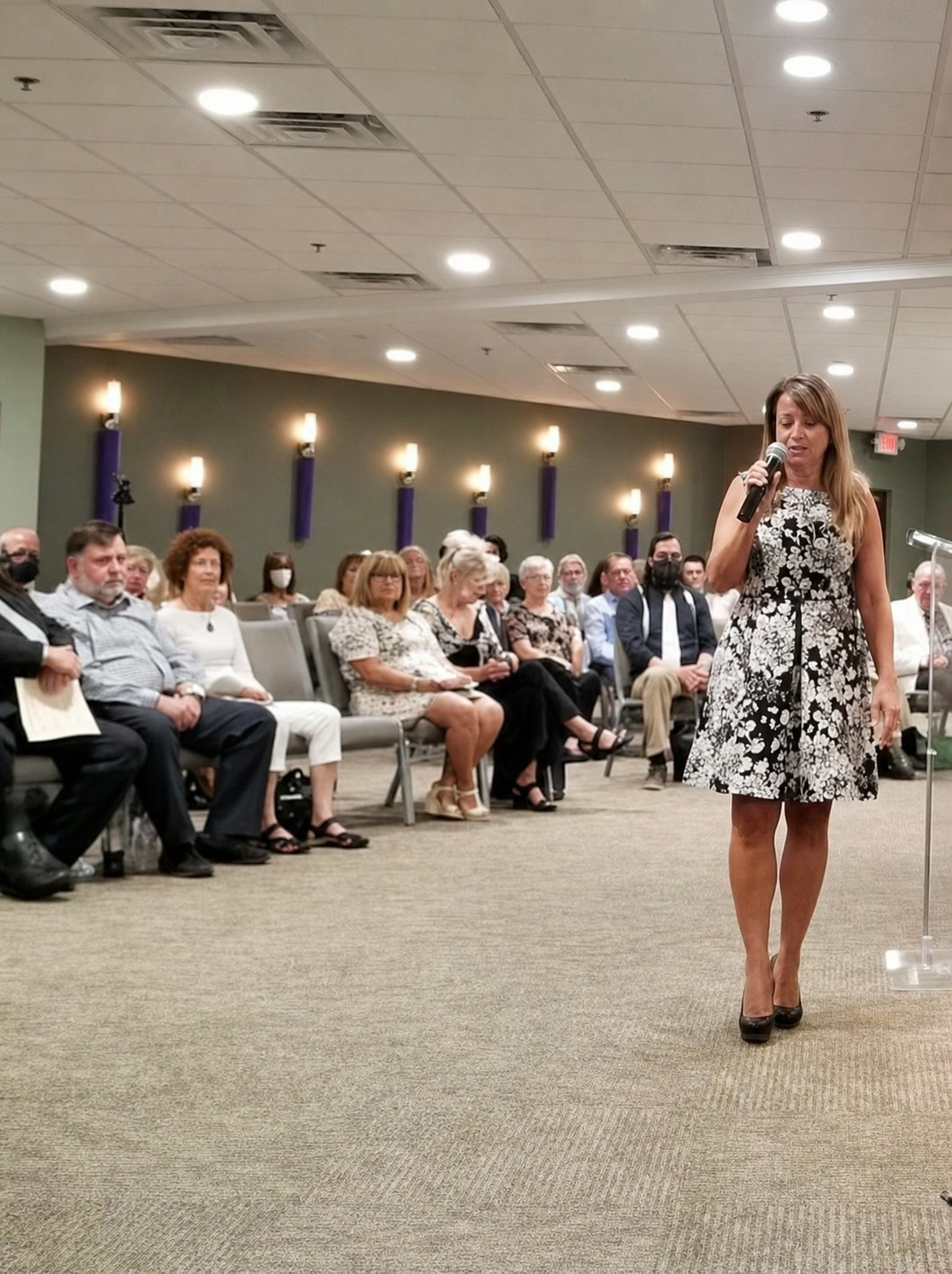 Cathryn Marshall speaking directly with an audience in an intimate room