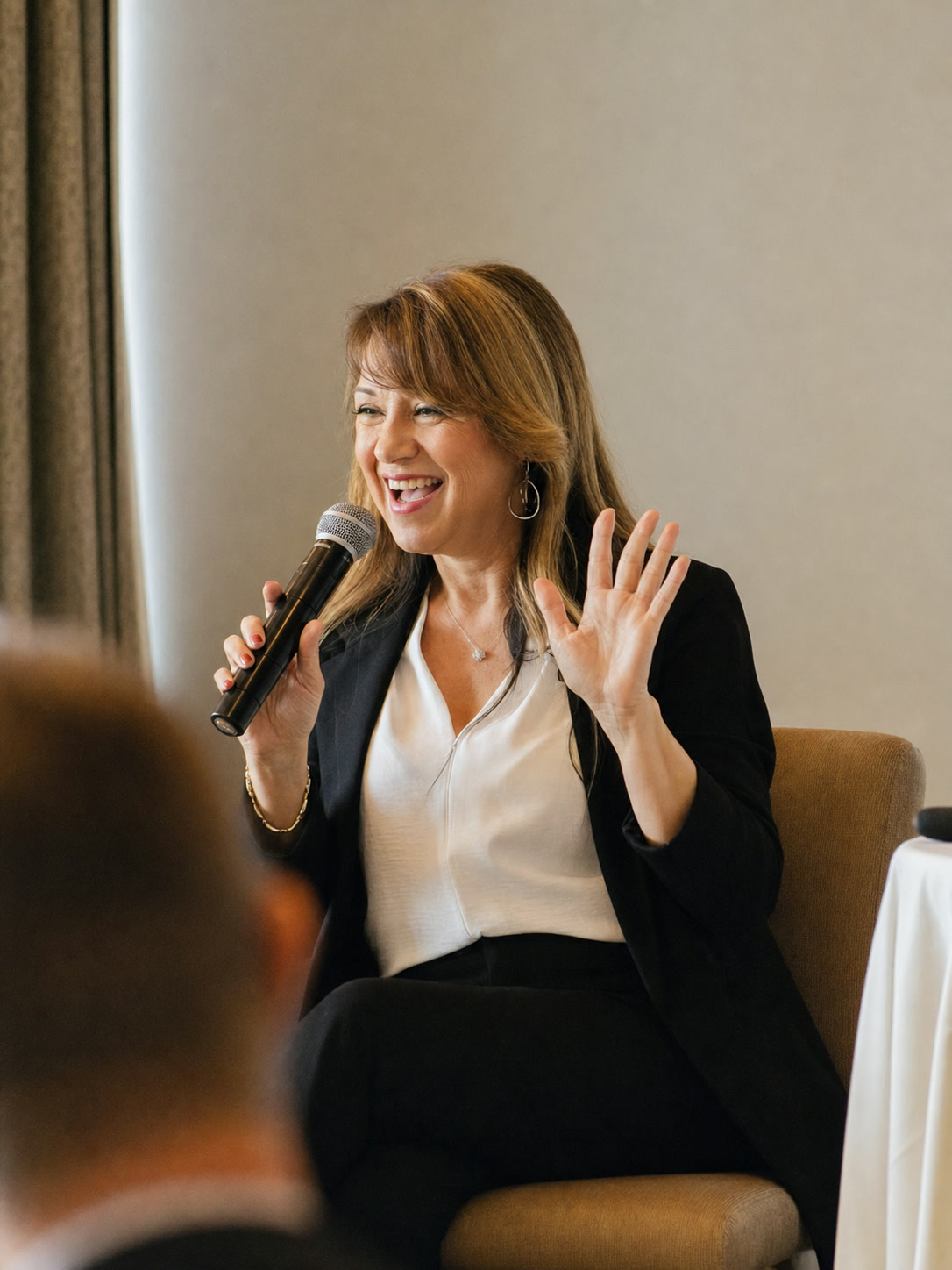Cathryn Marshall smiling while speaking in a short black jacket